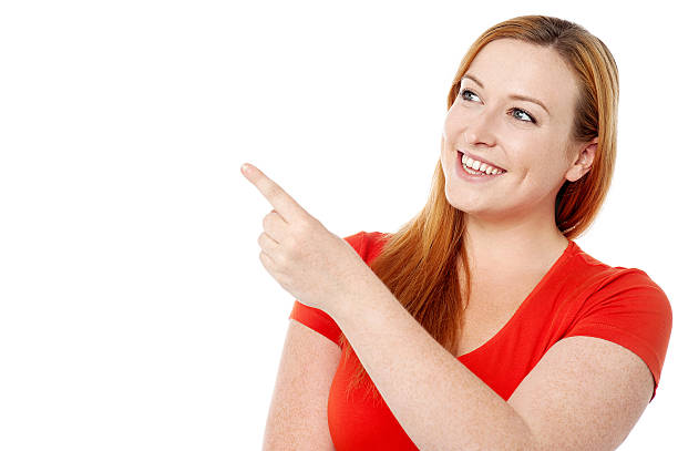 Pretty lady pointing at something stock photo