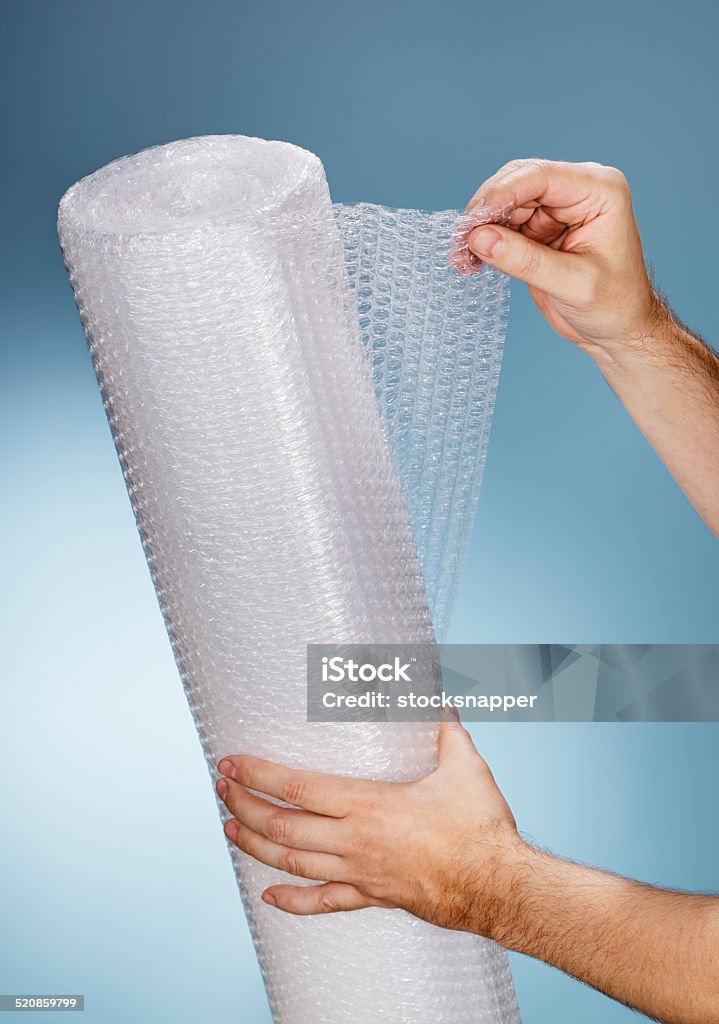 Bubble Wrap Man holding a roll of plastic bubble wrap. Bubble Wrap Stock Photo