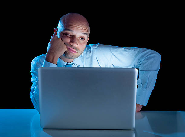 istock overworked businessman working on computer laptop late night  exhausted 520860641