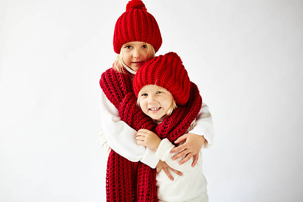 istock little sisters in warm clothes 520863039
