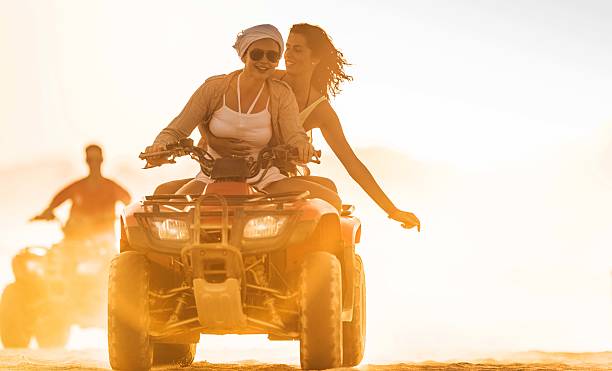 istock Friends driving quad bikes at sunset. 520863689