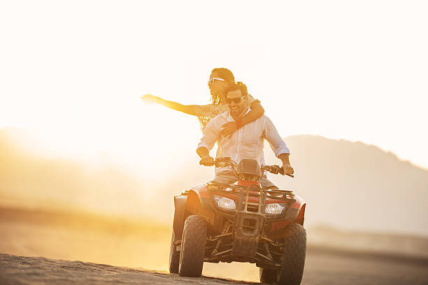 istock Driving quad bike at sunset. 520864647