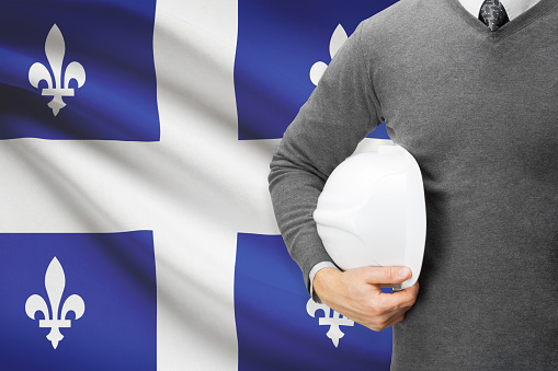 Architect with Canadian provinces and territories flag on background  - Quebec