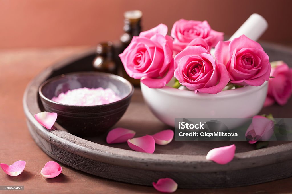 spa set with rose flowers mortar essential oils salt Alternative Therapy Stock Photo