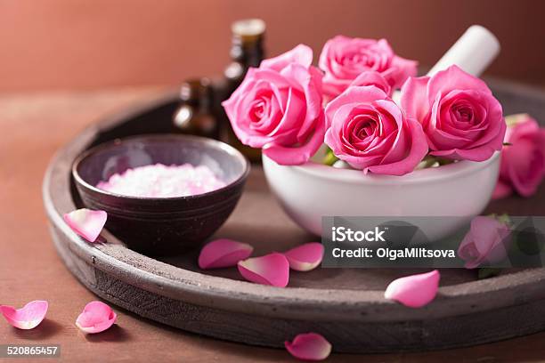 Spa Set With Rose Flowers Mortar Essential Oils Salt Stock Photo - Download Image Now