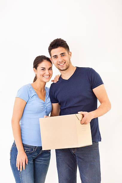 istock Young couple carrying cardboard box 520866439