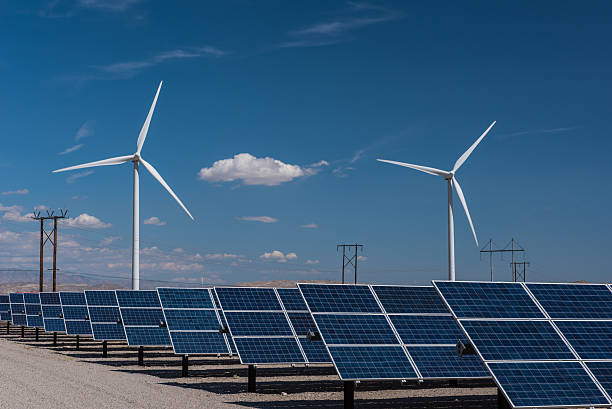 istock Solar panels and wind turbines in sunny desert 520876400