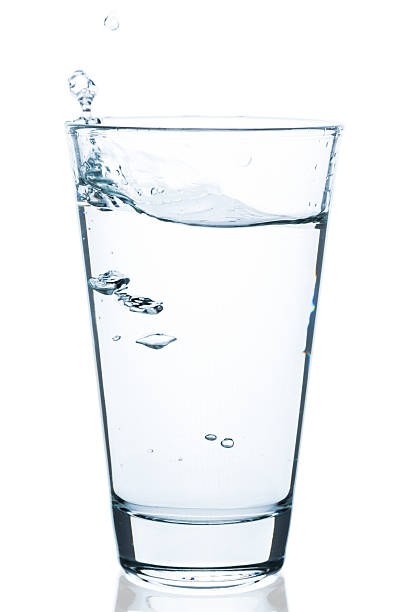 istock bubbling water with drops in water glass 520878930