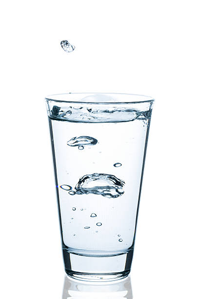 istock Water glass with splashing water and drops 520878992