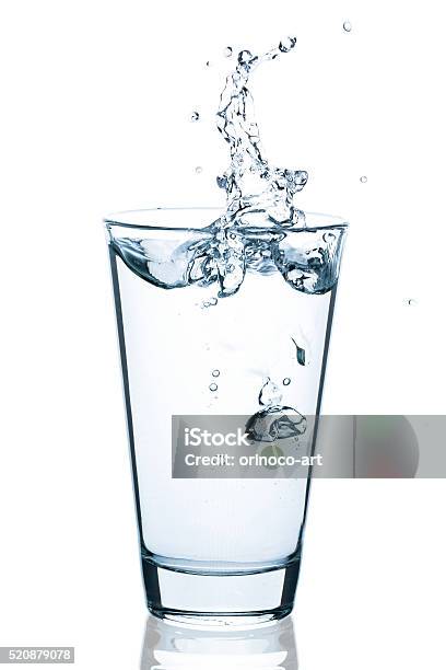 Water Glass With Splashing Water And Drops Stock Photo - Download Image Now - Drinking Glass, Cut Out, White Background