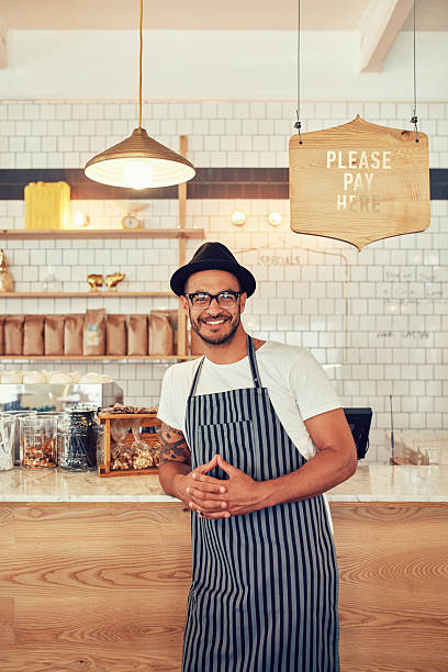 istock Coffee shop worker smiling to camera 520879944