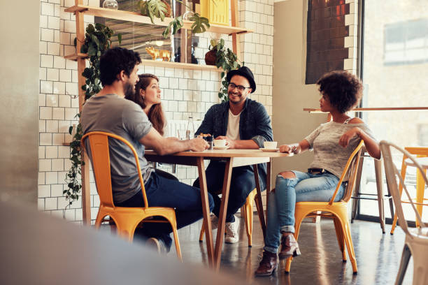 istock Young people sitting at a cafe table 520880116