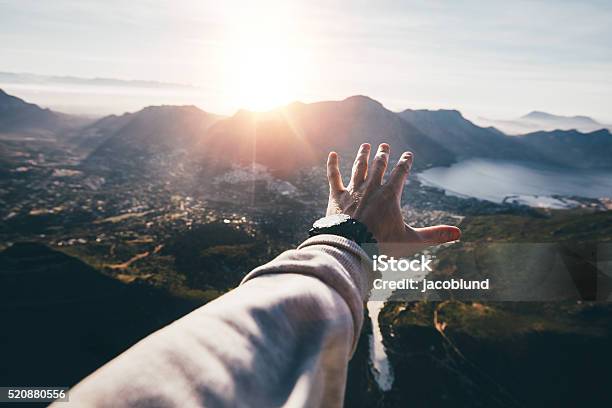 Hand Of A Man Reaching Out The Beautiful Landscape Stock Photo - Download Image Now - Reaching, Personal Perspective, Travel