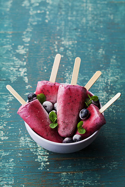 istock Blueberry ice cream or popsicles decorated green mint leaves 520880738