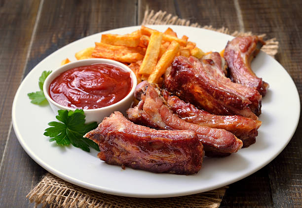 istock Pork ribs and tomato sauce on white plate 520881860