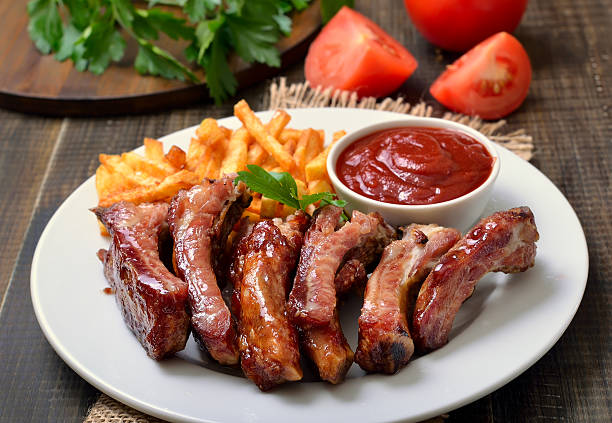 istock Barbecue pork ribs and vegetables on white plate 520882032