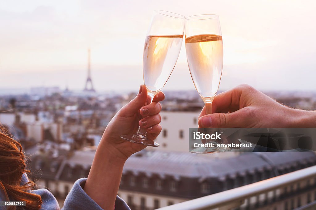 couple drinking champagne in Paris two glasses of champagne or wine, couple in Paris, romantic celebration of engagement or anniversary Paris - France Stock Photo