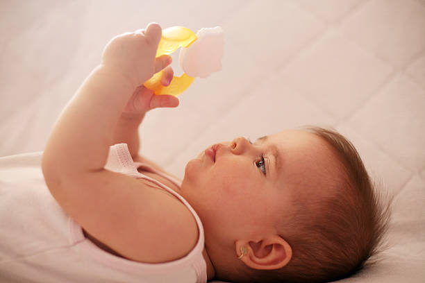 istock Baby girl exploring toy. 520883714