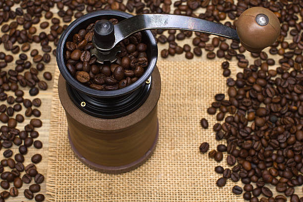 istock coffee mill full coffee beans on sackcloth 520884116