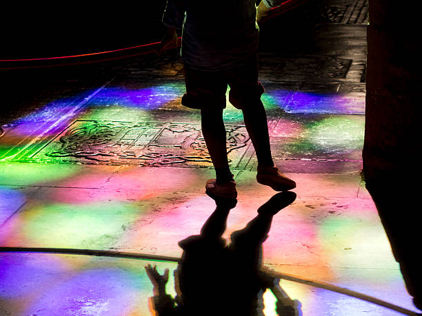 istock leg Silhouette on church tumb floor colored light reflections 520884763