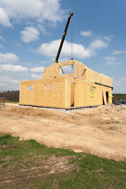 istock Frame house construction. View on new building with crane 520884984