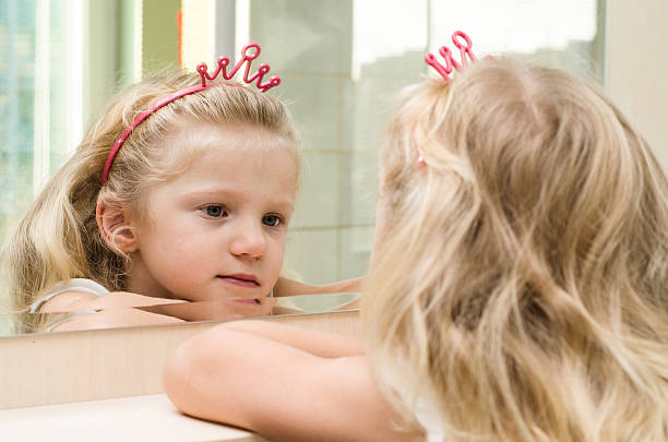 istock blond girl in mirror 520885079