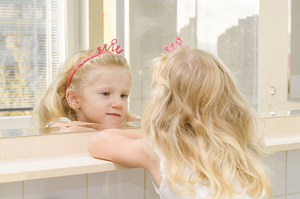 istock blond girl in mirror 520885091