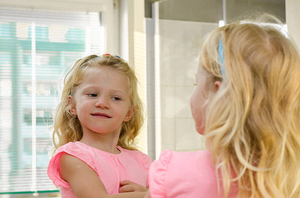 istock blond girl in mirror 520885139