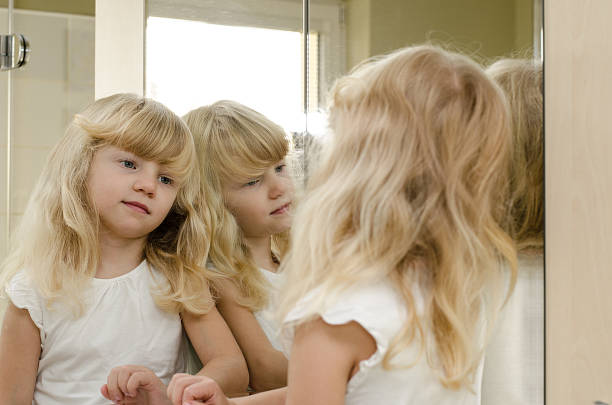 istock blond girl in mirror 520885199