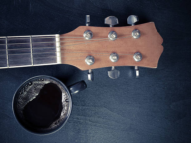 istock Coffee and guitar  on wooden table. 520885846