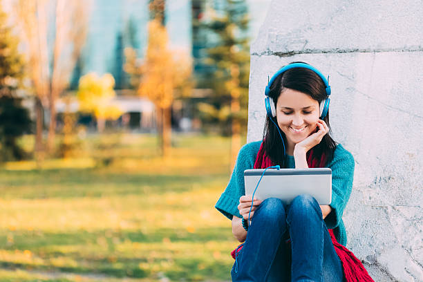 istock Woman with tablet outside 520886445
