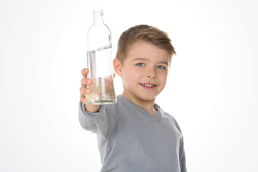 kid shows a bottle of water
