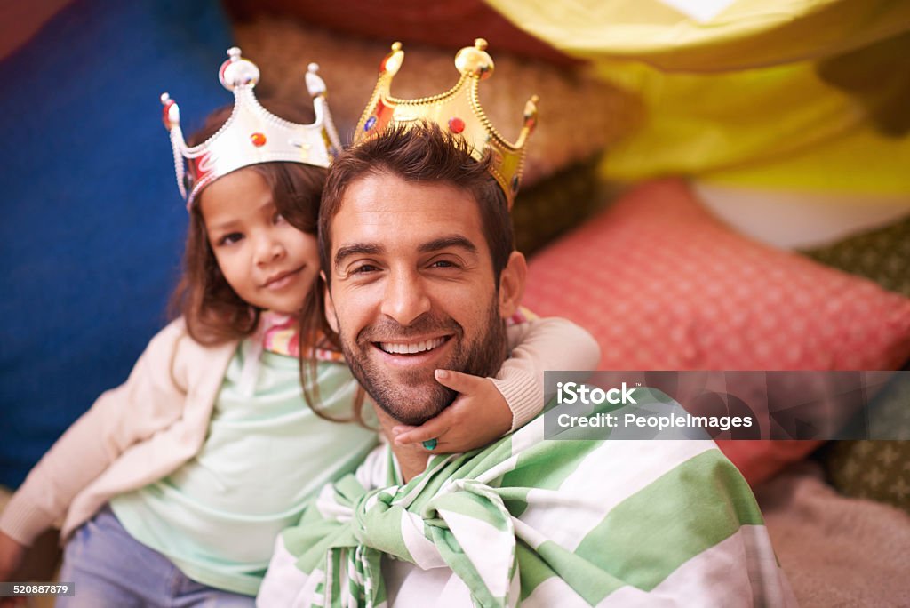 The Royal family...almost! A cute little girl dressed up as a princess while playing at home with her dad 30-39 Years Stock Photo