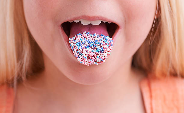 Mmmm, delicious! Cropped closeup of a little girl with candy on her tongue candy in mouth stock pictures, royalty-free photos & images