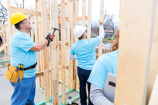 istock Diverse group work together on home built for charity 520888218