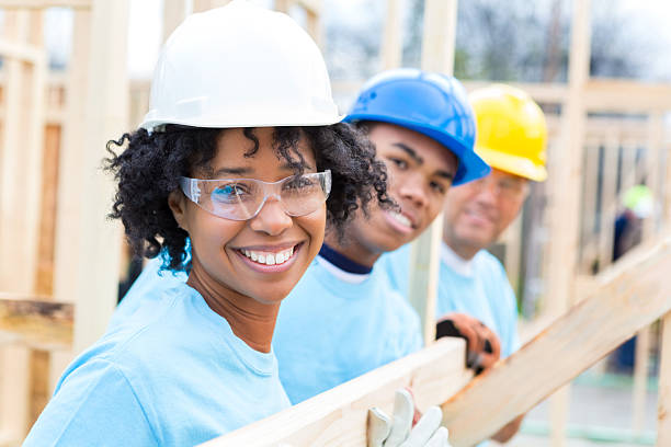 istock Happy volunteers at home construction site 520888284