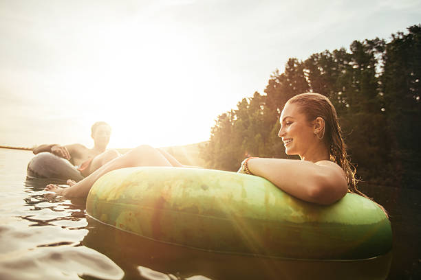 istock Young woman floating in an innertube at sunset 520888316