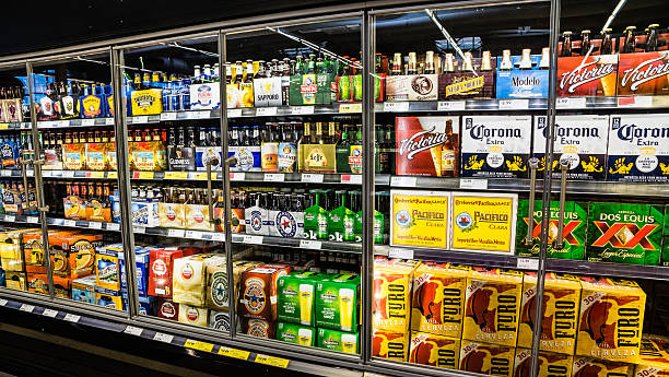 Grocery Store Beer Cooler LAS VEGAS - MARCH 25:  Grocery stores stock up on cold beer as March Madness and Cinco de Mayo spur hot weather  demand in Las Vegas on March 25, 2013. cooler container photos stock pictures, royalty-free photos & images