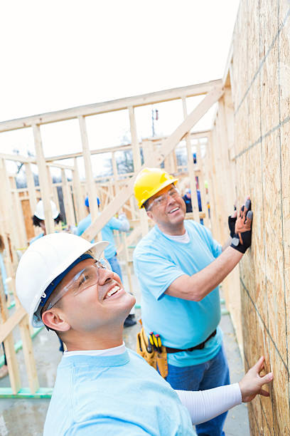 istock Diverse friends work together on charity home 520888944