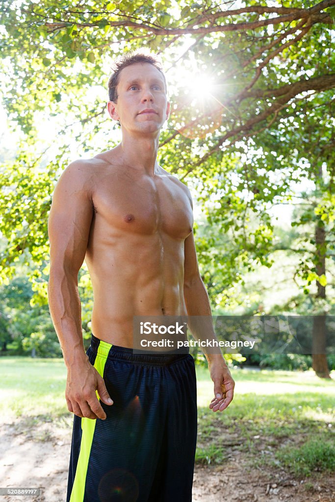 Muscualr Man with Jump Rope A muscular man stands in the park without a shirt. 20-29 Years Stock Photo