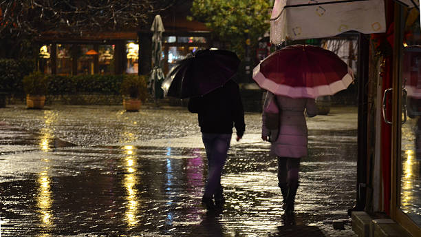 istock walking  in the night rain 520889522