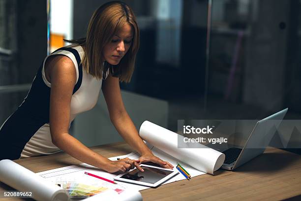 Architect Using Digital Tablet Late In Her Office Stock Photo - Download Image Now - Manager, Color Swatch, Looking