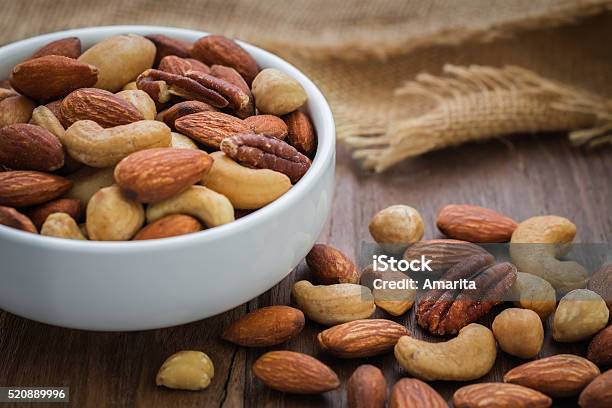 Mixed Nuts On Wooden Table And Bowl Stock Photo - Download Image Now - Nut - Food, Seed, Cashew