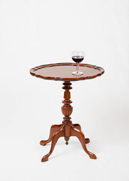 istock Glass of red wine on small vintage wine table 520890824