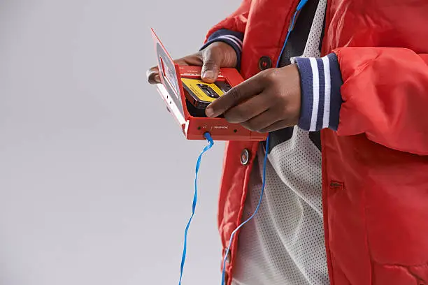 Cropped shot of a teen putting a cassete into a walkman