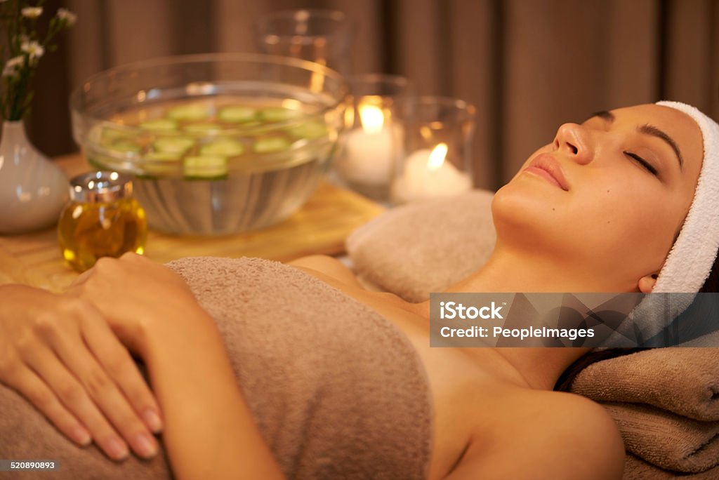 Letting her cares float away A young woman lying in a day spa Abstract Stock Photo