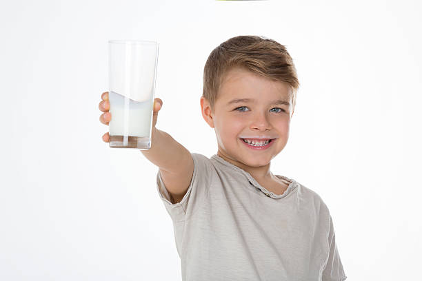 child commercial image kid shows a glass full of milk little boys blue eyes blond hair one person stock pictures, royalty-free photos & images