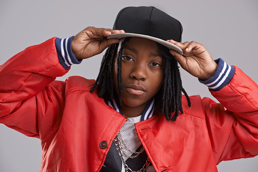 Studio shot of a young boy dressed in hip hop attire