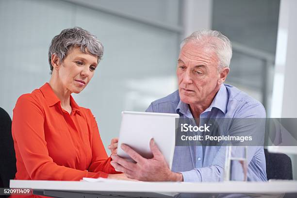 Examining Their Business Plan Stock Photo - Download Image Now - Adult, Adults Only, Analyzing