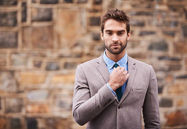 Cool confidence Portrait of a handsome and stylish young businessman in an urban setting man adjusting tie stock pictures, royalty-free photos & images